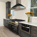 ZLINE Autograph Edition 48 in. 6.0 cu. ft. Legacy Dual Fuel Range with 7 Burner Gas Cooktop and 2 Electric Ovens in Stainless Steel with Black Matte Doors and Champagne Bronze Accents (RAZ-BLM-48-CB) in a luxury kitchen with matching appliances.